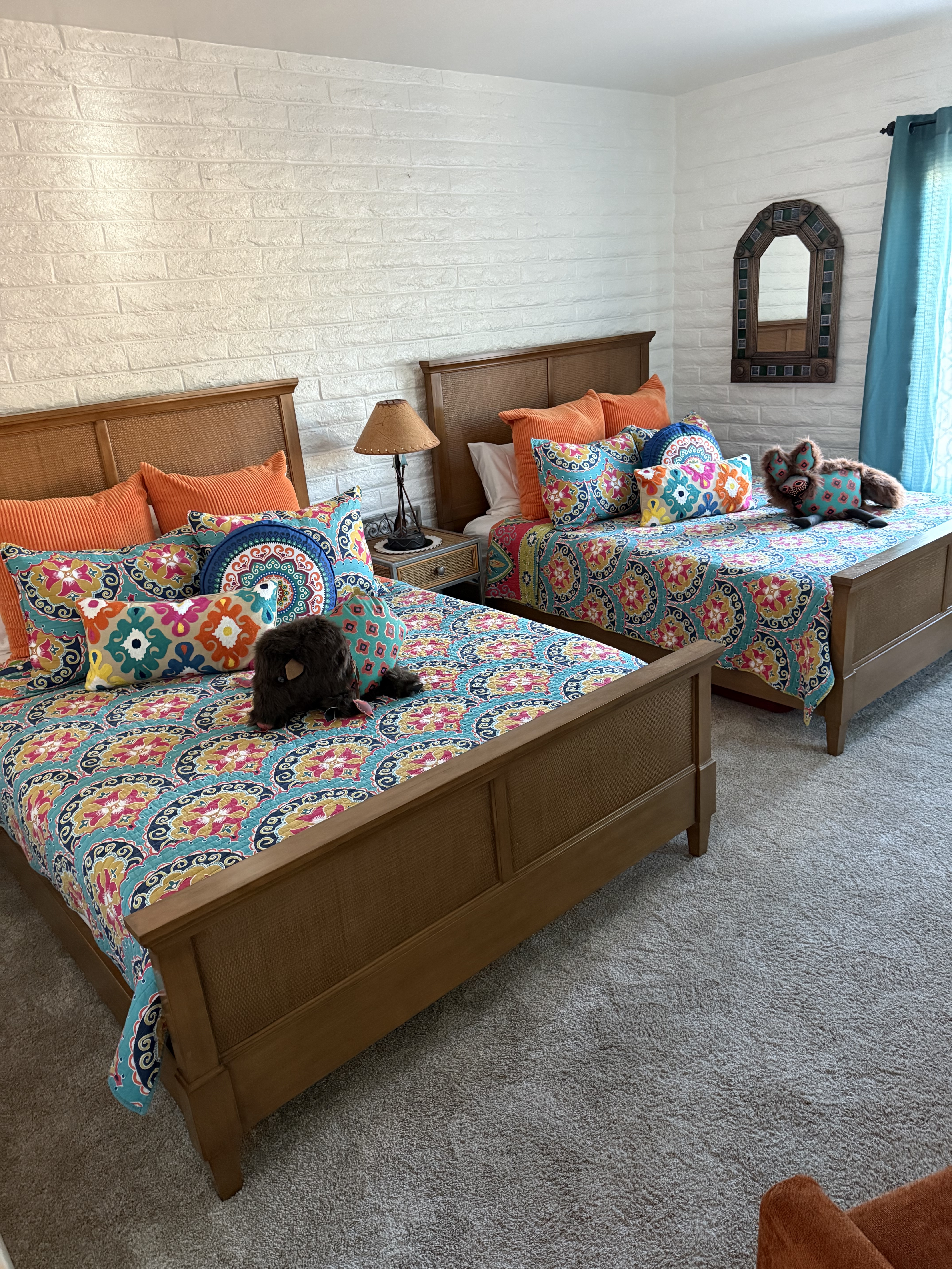 Freshly cleaned and styled guest bedroom with two made beds